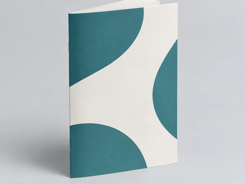 Stapled booklet lying open showing a two-page spread