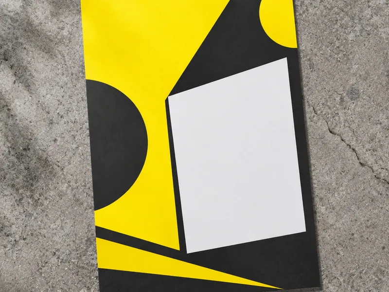 Single page flyer held up against a blurred street background